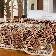 a leopard print bed spread on top of a wooden floor