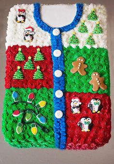 a cake that is shaped like a sweater with christmas decorations on the front and sides