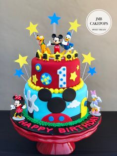 a birthday cake with mickey mouse and friends on it