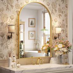 a bathroom with a sink, mirror and flowers in vases on the counter top