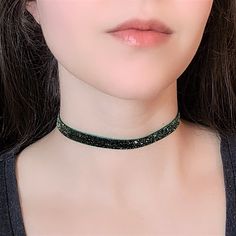 "A dark green choker featuring thin glitter velvet ribbon and bronze adjustable clasp. The length shown in photos is 12\" and more options are available. Each size comes with an additional 2.5\" extender chain. For best fit, measure around the smallest part of your neck (close to center) and choose the next smallest size. If you would like a different length, send me a message and I can make that for you :) Ribbon clamps, lobster clasp and chain are antique bronze tone alloy. Jewelry Care Tips F Egirl Necklace, Glitter Choker, Fairycore Necklace, Green Choker, World Necklace, Gothic Choker, Goth Choker, Velvet Necklace, Velvet Choker Necklaces