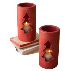 two red candles sitting on top of each other