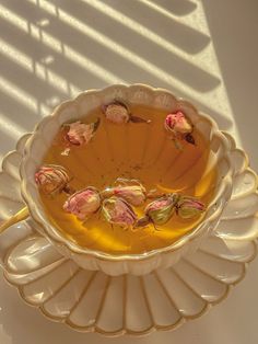 a bowl filled with flowers sitting on top of a table