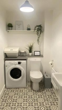 a washer and dryer in a small bathroom with tile flooring on the walls