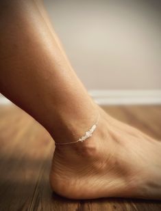 Gorgeous raw natural moonstone chips on bar style anklet with an extender and white crystal charm at the end. Giving it that delicate romantic look. In sterling silver or 14k gold filled chain. ⭐️⭐️⭐️⭐️⭐️Chain length is 9 inches unless you need shorter or longer you can message me or put in the comment box at purchase. Please measure your ankle length and leave about 1 inch extra for total length.⭐️⭐️⭐️⭐️⭐️ 💜Simple, Dainty and Elegant Raw Natural Stone for everyday wear. I usually wear it with Moonstone Anklet, Stone Anklet, Dainty Anklet, Bar Styling, Protection Stones, Crystal Charm, Quartz Rose, Anklet Jewelry, White Crystal