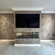 a flat screen tv mounted to the side of a wall above a fireplace in a living room