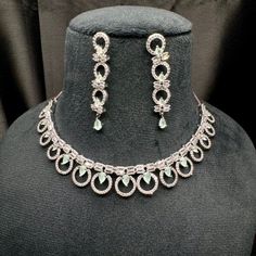 . Glamorous Round Necklace With Sparkling Stones, Elegant Jewelry Sets For Parties, Glamorous Bridal Earrings With Diamond Accents, Glamorous Round Bridal Earrings With Diamond Accents, Glamorous Round Necklaces With Diamond Accents, Elegant Crystal Embellished Jewelry For Gifts, Glamorous Round Cubic Zirconia Necklaces, Elegant Round Cut Rhinestone Necklace, Elegant Silver Circle Necklace