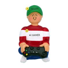 a ceramic ornament with a man holding a game controller in his lap and the words scott on it