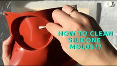 a person is holding a red ashtray in their left hand with the words how to clean silicone molds?