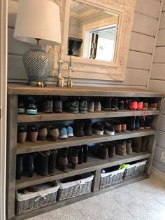 a large shelf with many pairs of shoes on it and a mirror above the shelves