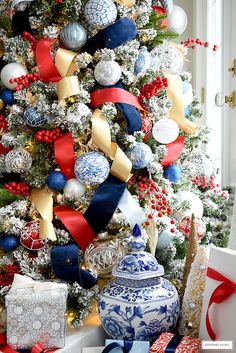 a decorated christmas tree with red, white and blue ornaments