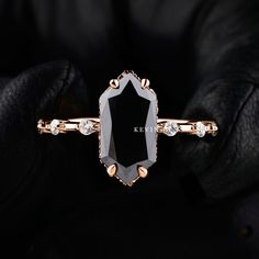 a black and white diamond ring with gold accents