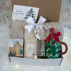 a christmas gift box filled with gifts and cards