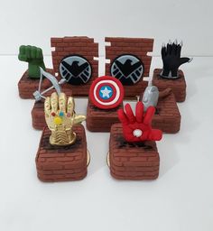 some toys are sitting on top of bricks and placed in the shape of superheros