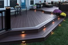 a deck lit up with lights and flowers