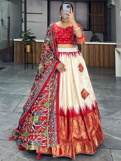 Elevate your ethnic wardrobe with our stunning "adorable off-white & red patola printed silk festival wear lehenga choli." Crafted from high-quality dola silk material in off-white and red colors, this traditional ensemble is adorned with intricate patola and paithni printed work, along with shimmering foil work (crush work) that adds a touch of glamour to the outfit.
This lehenga choli set include a lehenga stitched up to 42 inches with a 3.8-meter flair, a 41-inch lehenga length, and an un Red Anarkali Sharara With Kalamkari Print, Off White Traditional Wear For Navratri, Festive White Ikat Print Saree, White Kalamkari Print Sets For Festivals, Ikat Print Lehenga For Wedding And Festivals, Festive Multicolor Ikat Print Lehenga, Traditional White Ikat Print Wear, Festive Ikat Print Traditional Wear For Wedding, Wedding Lehenga With Ikat Print For Festivals