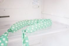 a green and white polka dot tie on top of a refrigerator