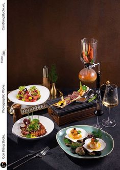 a table topped with plates of food and wine