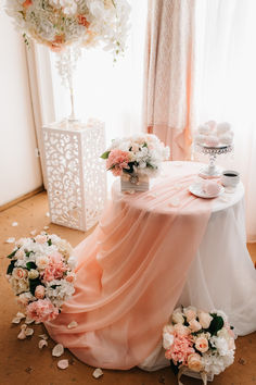 the table is covered with pink and white flowers