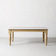 a wooden bench sitting on top of a white floor