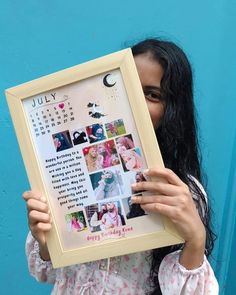 a woman holding up a framed photo with pictures on it and the words july written in cursive writing