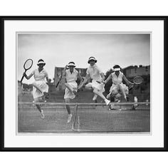 black and white photograph of four men playing tennis