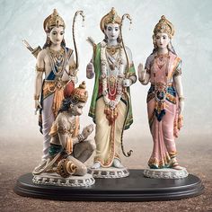 three statues of hindu deities on a table