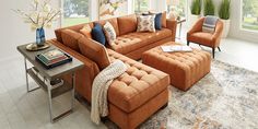 a living room with orange couches and chairs