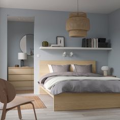 a bedroom with blue walls and wooden furniture