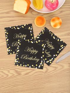 two happy birthday cards sitting on top of a table next to sliced apples and cheese