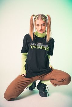 a woman sitting on the ground with her hands in her pockets and headbands