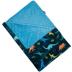 a blue blanket with dinosaurs on it and a blue dotty cloth under the cover