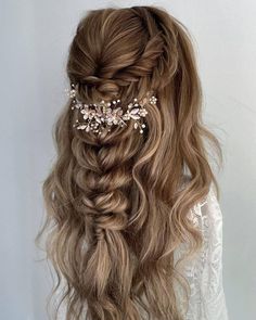 a woman with long hair wearing a wedding hairstyle