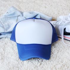 The perfect blue trucker hat for the season. A sweet blue pairs with soft mesh sides and a white front. Darling paired with a tee & jeans. Color: Blue Adjustable Blue Sporty Baseball Cap, One Size Fits Most, Sporty Blue Baseball Cap, One Size Fits Most, Sporty Blue Baseball Cap One Size Fits Most, White Mesh Snapback Hat For Spring, Sporty Blue Baseball Cap One Size, White Mesh Trucker Hat For Spring, Summer Blue Baseball Cap With Curved Brim, Blue Summer Baseball Cap With Curved Brim, Blue Curved Brim Baseball Cap For Summer