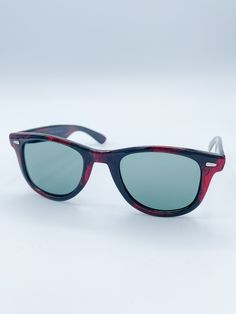 Our Vintage Wayfarer French Vintage Sunglasses are the perfect retro-look for any summer outfit. Crafted with a lightly colored frame and colorful lenses in orange, teal, red or blue, these sunglasses offer a unique, stylish look that stands out from the crowd. ​Details: Medium Squared Wayfarer Style Colors available: Blue, Teal, Red or Orange Freeform Color on Black Frame "Made in France" Printed on Temple Approximate Dimensions: 5.75" x 1.75" Light weight Casual Wayfarer Sunglasses With Tinted Lenses, Retro Wayfarer Sunglasses With Uv Protection, Retro Wayfarer Sunglasses With Anti-reflective Coating, Retro Anti-reflective Wayfarer Sunglasses, Casual Anti-reflective Wayfarer Sunglasses, Summer Wayfarer Sunglasses With Glass Material, Summer Wayfarer Sunglasses With Glass Lenses, Glass Wayfarer Sunglasses For Summer, Summer Glass Wayfarer Sunglasses