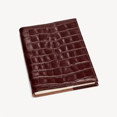 a brown leather book with an alligator skin pattern