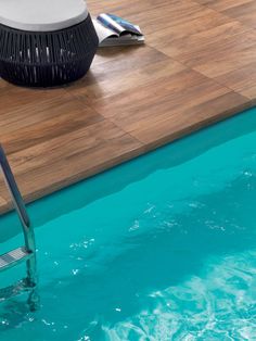 an empty swimming pool with water coming out of the side and a blow dryer on the floor