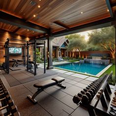 an indoor gym with a swimming pool and exercise equipment