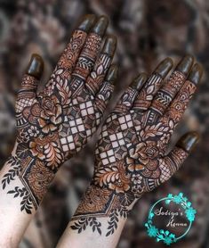 two hands with henna designs on them