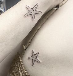 two starfish tattoos on the side of a woman's right arm and shoulder