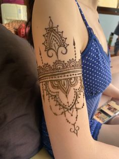 a woman with a henna tattoo on her arm