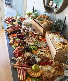 a buffet table filled with lots of food and snacks on it's sides,