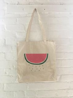 "This 100% cotton tote bag is printed with a hand drawn watermelon with falling seeds. This bag is good for the farmer's market, as a grocery tote bag, or for the beach. It is printed with green and red ink and shown on a natural tote bag. We screen print these tote bags to order in our shop in Connecticut. Since these tote bags are each hand crafted and made to order, there may be slight variations in placement, but they are all beautiful! // FABRIC: 100% cotton // COLOR: Printed with green and Summer Reusable Canvas Bag, Rectangular Canvas Bag With Eco-friendly Ink For Summer, Eco-friendly Ink Canvas Bag For Everyday Summer Use, Summer Reusable Canvas Shopping Bag, Grocery Tote Bag, Food Bag, Beach Tote Bag, Grocery Tote, Screen Printing Shirts