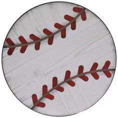 a baseball ball painted on top of a white wooden board with red stitching around it