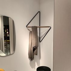 a towel hanging on a rack next to a mirror