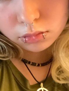 a girl with piercings on her nose and nose ring