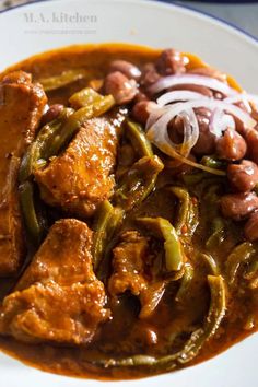 a white plate topped with meat and beans