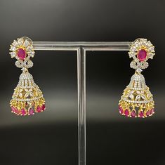 A beautiful premium quality AD jhumkas,perfect for all occasions. Diamond Jhumkas With Intricate Design In Bollywood Style, Diamond Jhumkas With Latkans For Festivals, Diamond Chandbali Jhumkas With Latkans, Fusion Style Jhumkas For Reception With Stone Work, Fusion Style Stone Work Jhumkas For Receptions, Bollywood Style Diamond Jhumkas, Formal Festive Jhumkas With Latkans, Festive Elegant Jhumkas For Celebration, Traditional Cubic Zirconia Jhumkas For Festive Occasions