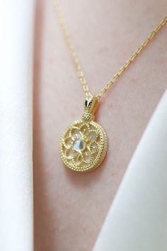 Sofia Sailormoon Floral Moonstone Pendant Necklace has a lovely gold flower pattern with a moonstone in the middle. Made with 18k gold vermeil. ◊ 18k Gold Vermeil ◊ Necklace length approximately measures 44 cm, pendant 1.1 cm wide ◊ Delivered in our signature Pina Blue Box, perfect for gifting yourself and loved ones! Delicate Moonstone Gold Jewelry, Delicate Gold Moonstone Jewelry, Gold Moonstone Round Necklaces, Gold Moonstone Necklaces For Anniversary, Gold Moonstone Necklace For Anniversary, Round Gold Moonstone Necklaces, Gold Moon Phase Necklace For Wedding, Intricate Moonstone Jewelry For Gift, Intricate Moonstone Jewelry As A Gift