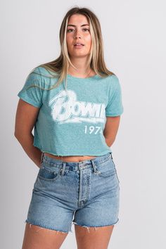 Vintage Bowie band tee from Lush Fashion Lounge women's boutique in Oklahoma City. Lush boutique in OKC has a variety of cute band tees and more! This vintage style band tee is a must have! The vintage distressing of this tee makes for the perfect concert look! Model is 5'9 size 28 wearing size medium. 100% cotton Summer Band Merch Cropped T-shirt With Crew Neck, Vintage Crew Neck Crop Top For Spring, Spring Vintage Crew Neck Crop Top, Summer Band Merch Cropped T-shirt, Summer Band Merch Cropped T-shirt With Short Sleeves, Band Merch Cropped T-shirt For Summer, Green Letter Print Crop Top, Retro Crew Neck Crop Top With Screen Print, Green Graphic Tee Crop Top With Letter Print